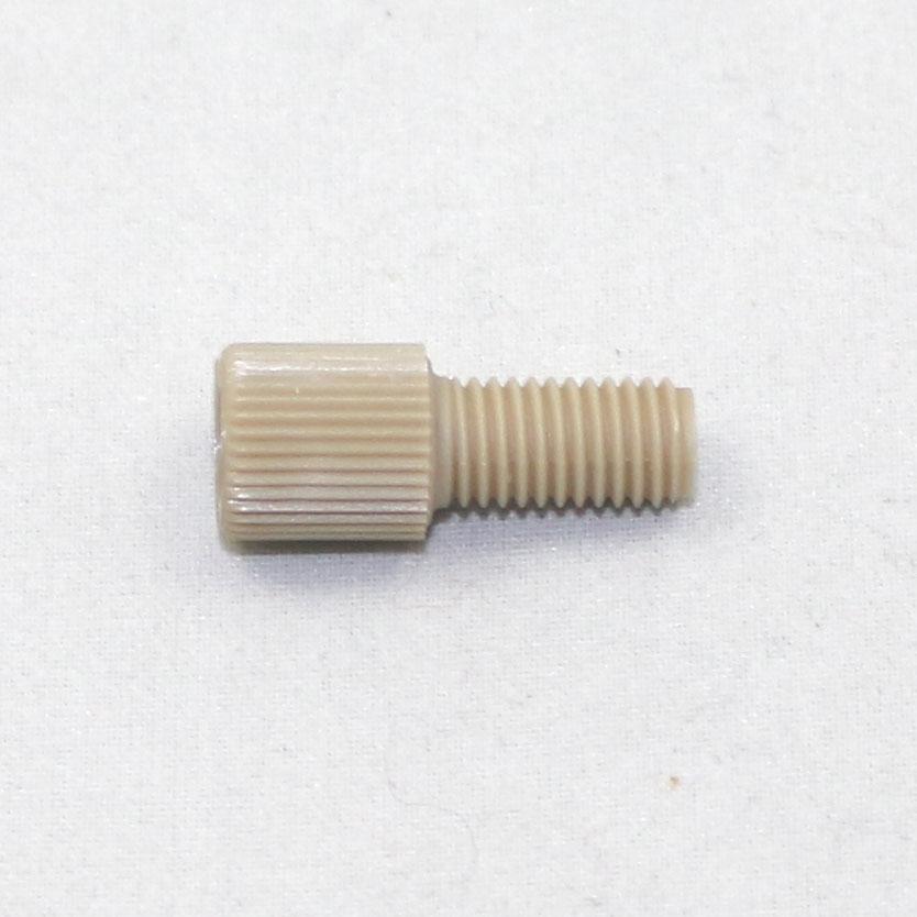 Beige threaded cylindrical object on a white background
