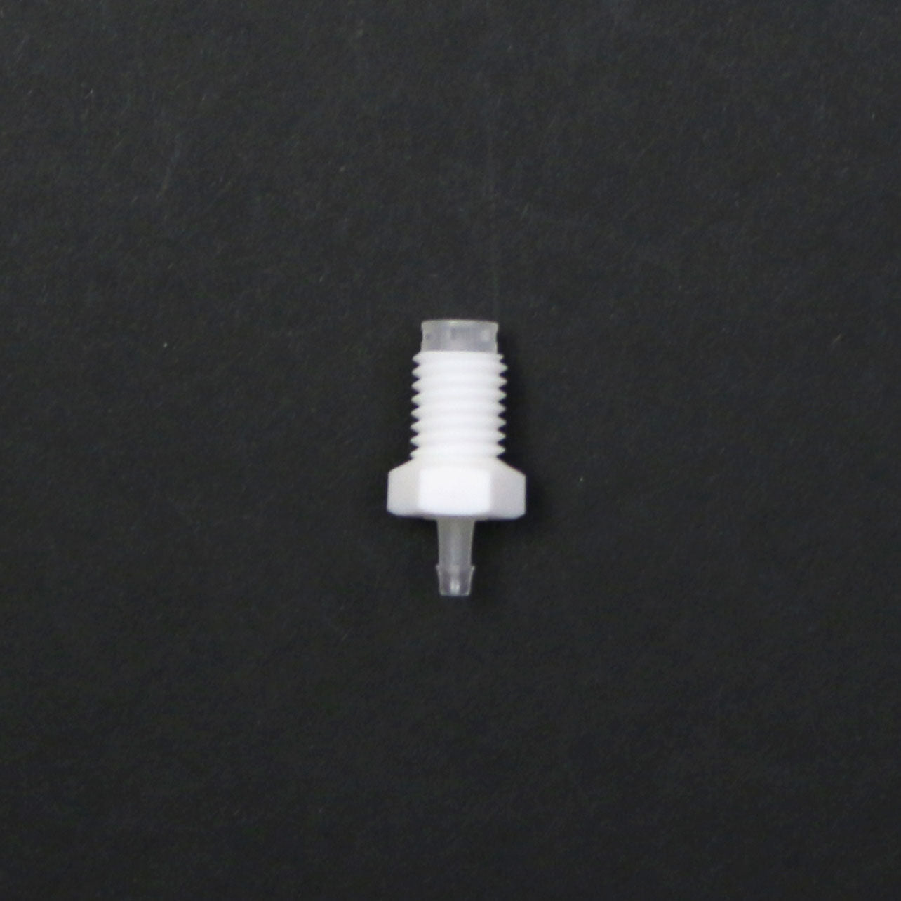 White plastic fitting on a black background