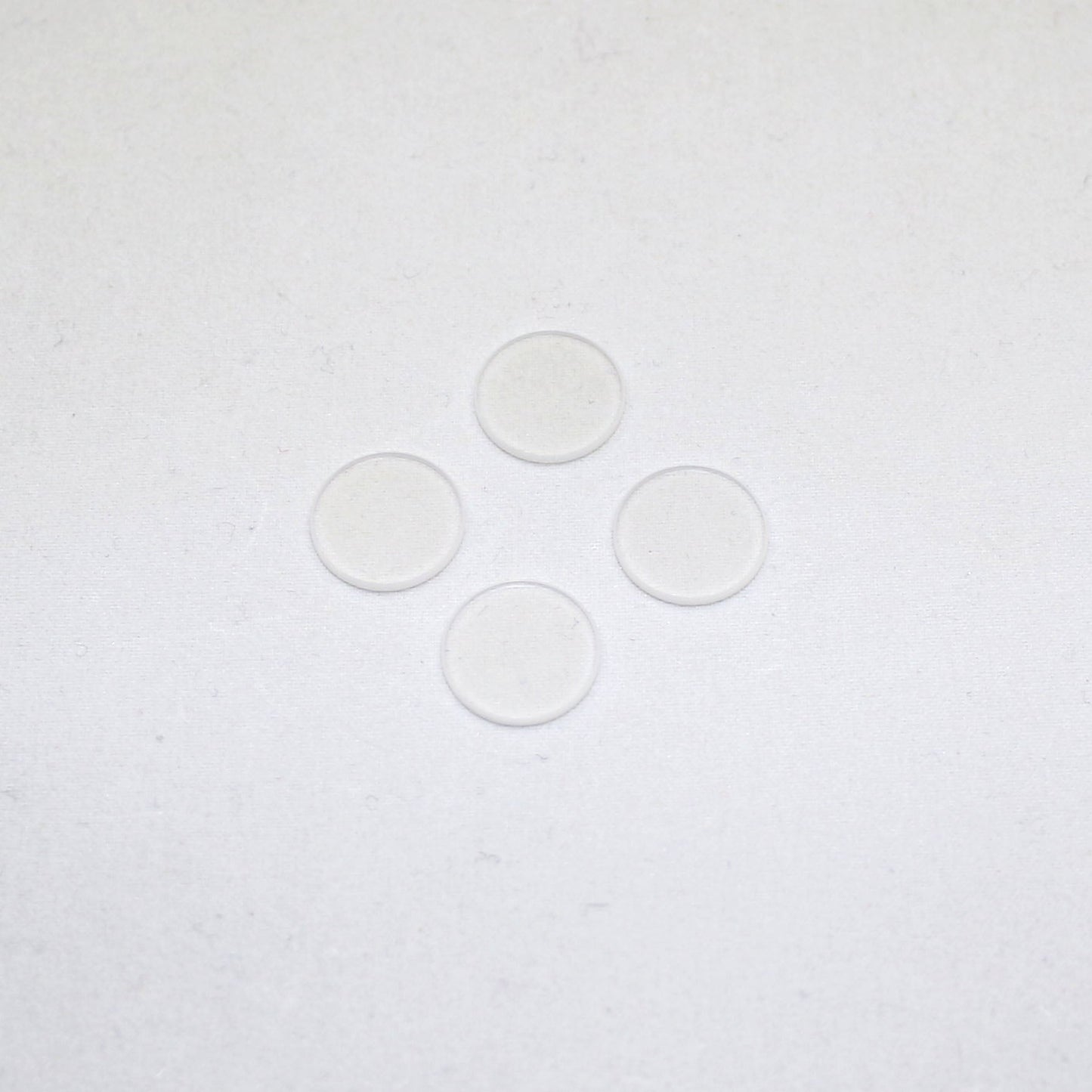 Four clear circular objects on a white background