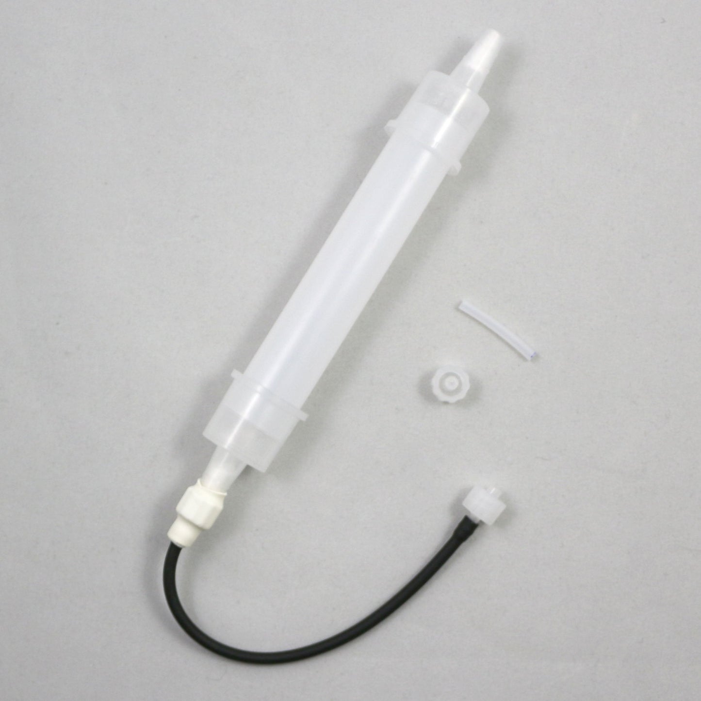 White plastic tube with black cable on a gray background