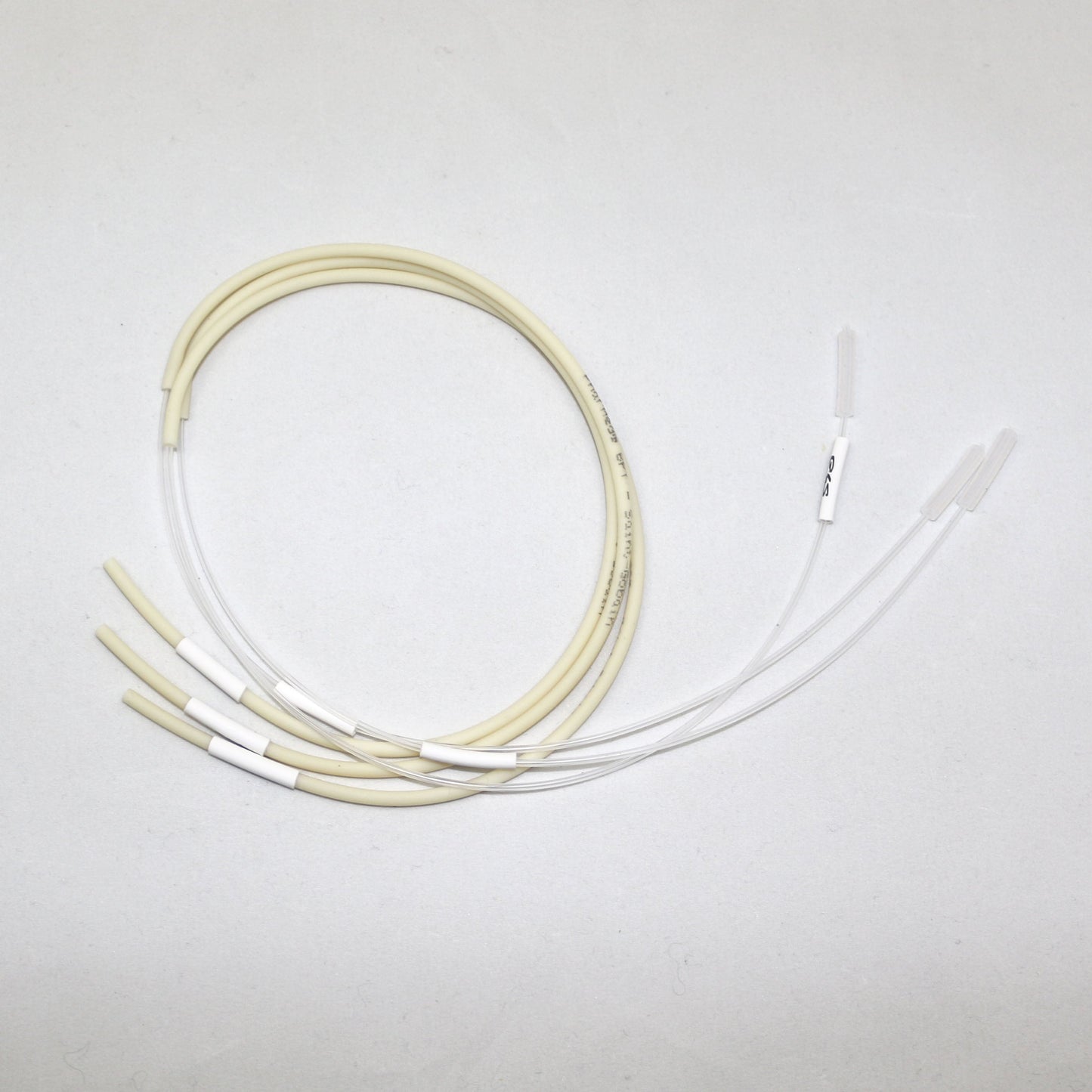 Set of white and beige tubes on a light gray background