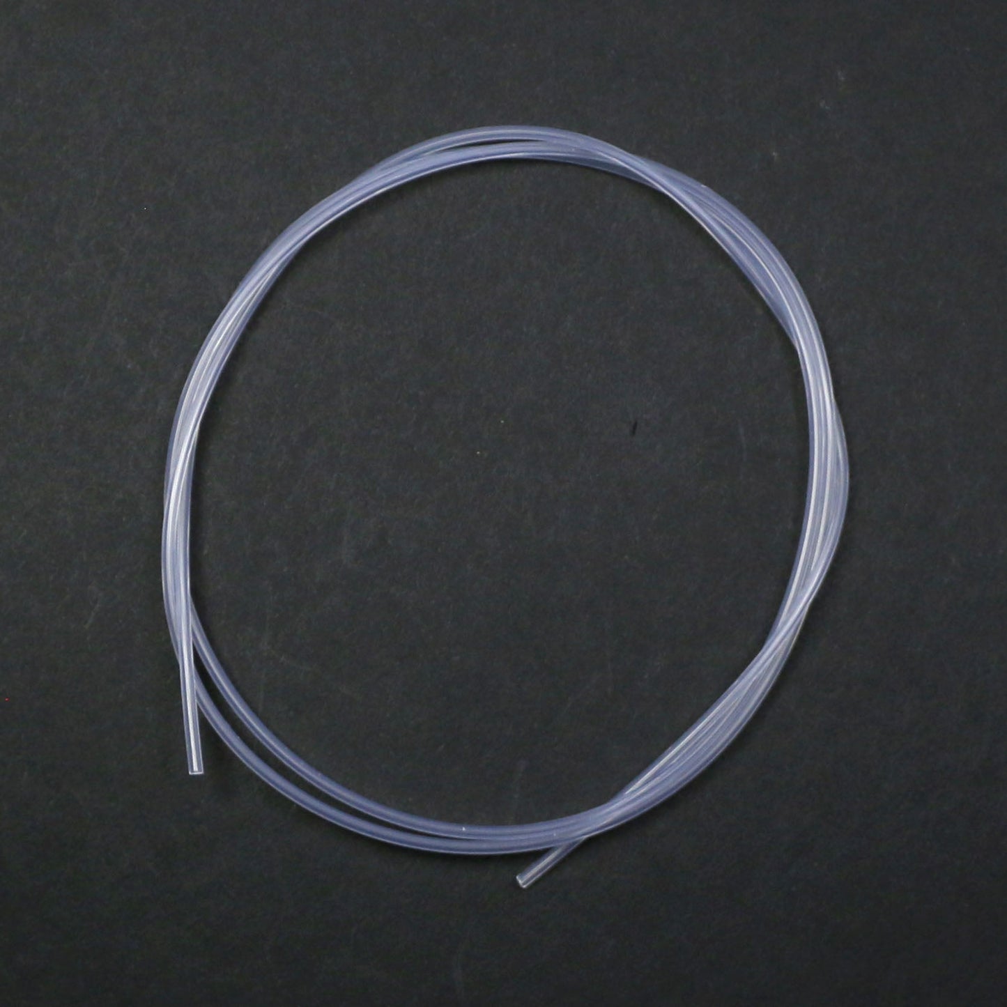 Clear silicone tube on a dark gray background