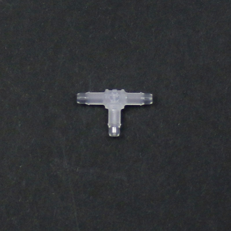 Clear plastic T-shaped connector on a black background