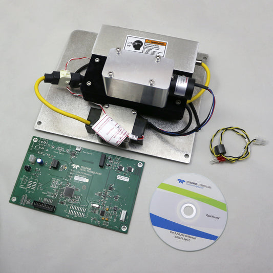 Electronic components including a circuit board, metal block with wiring, and a CD on a gray background