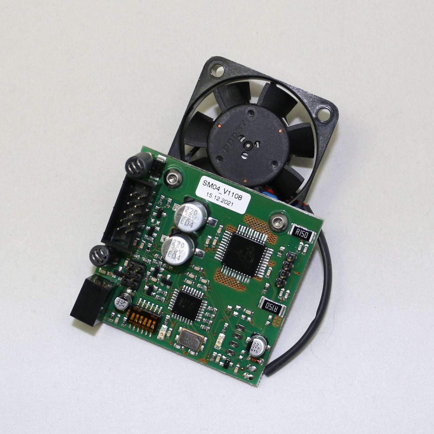 Electronic circuit board with a fan on a white background