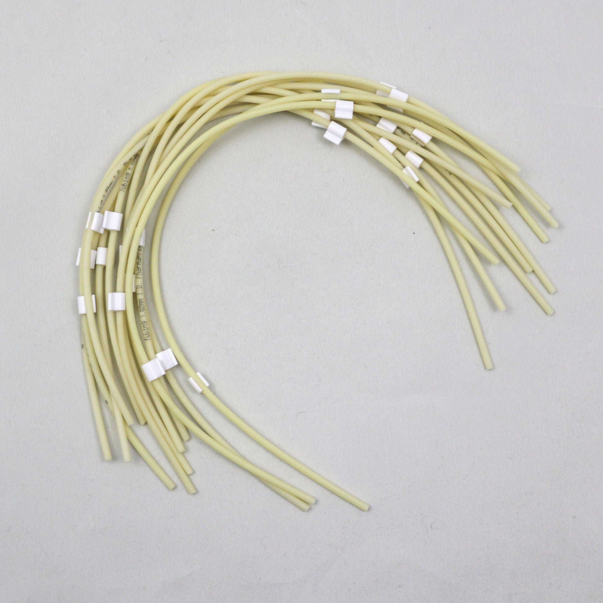 Set of tubing pieces with white tabs on a white background