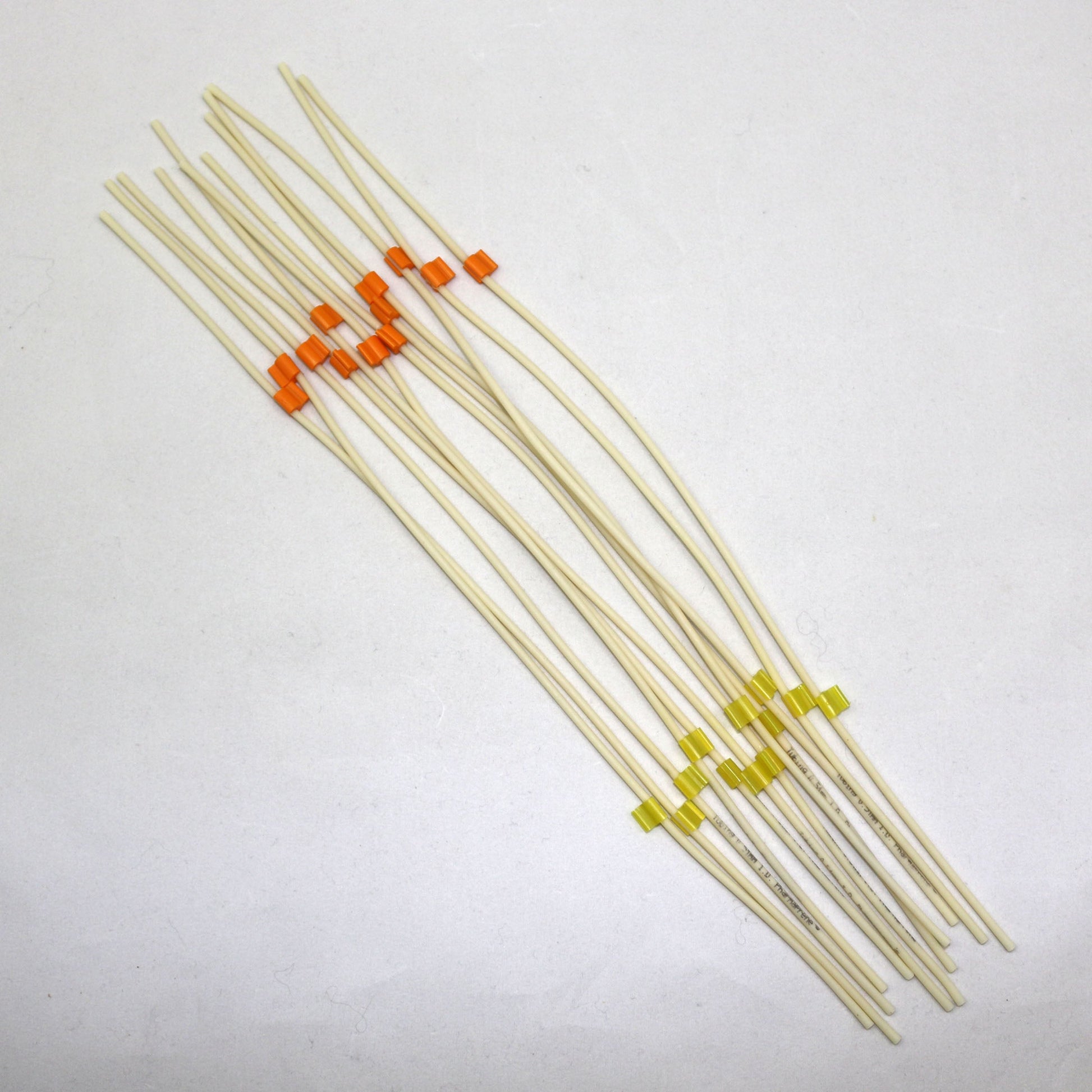 Set of tubing pieces with colored ends on a white background