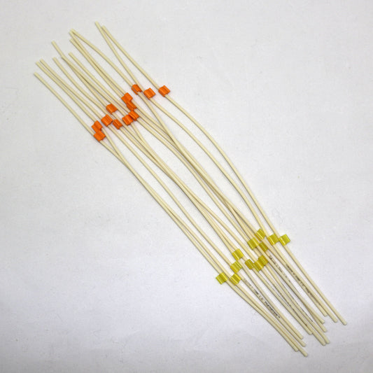 Set of tubing pieces with colored ends on a white background