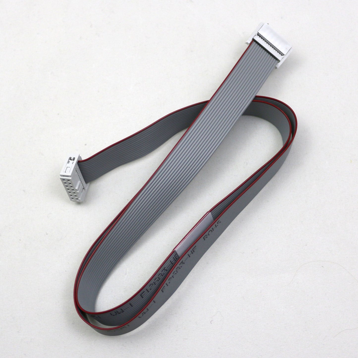 Gray ribbon cable with connectors on a white background