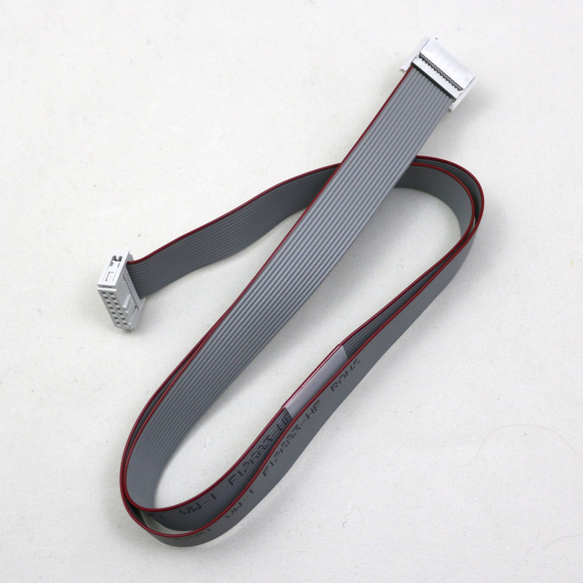 Gray ribbon cable with connectors on a white background