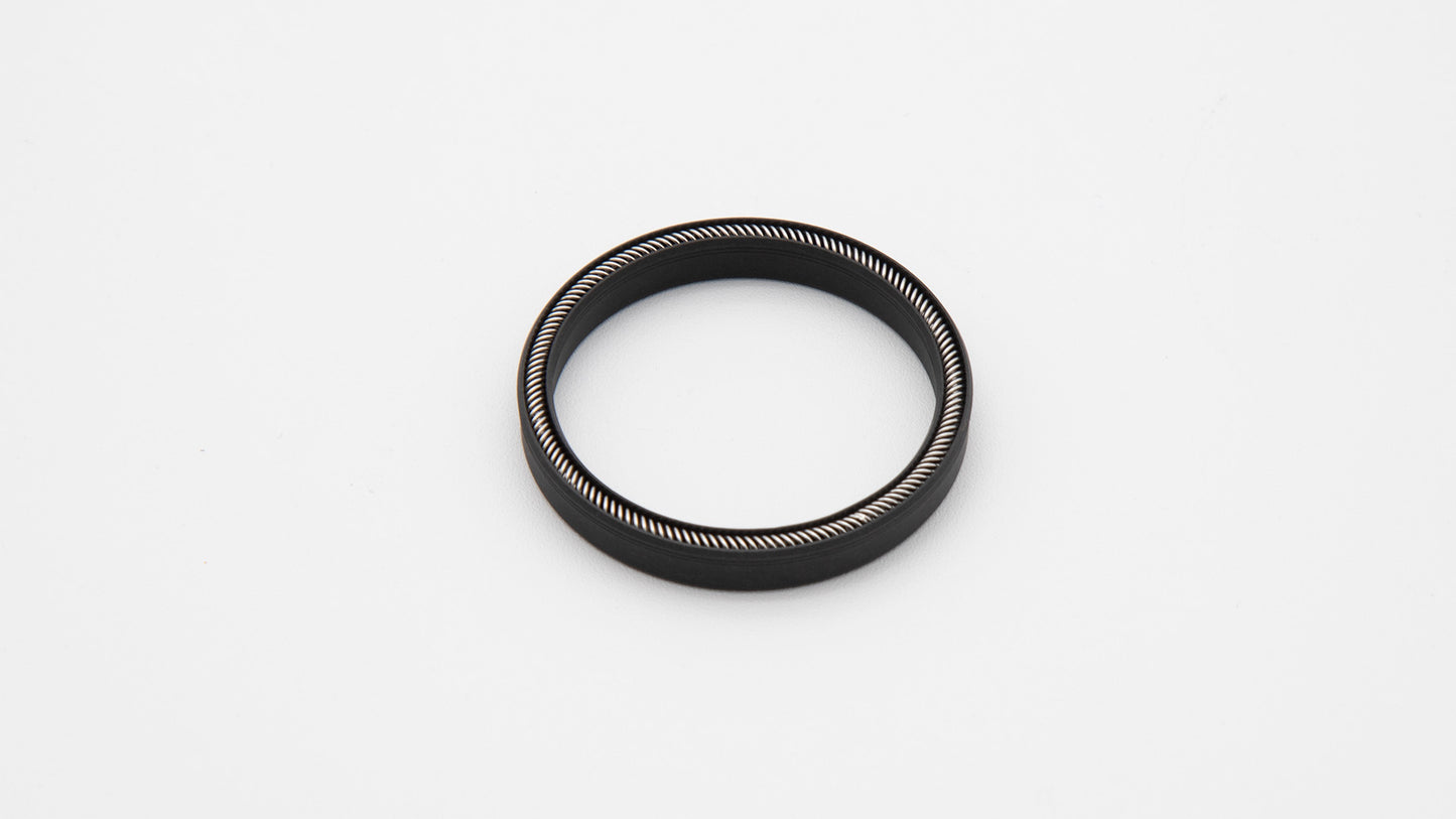 Round black object with installed spring