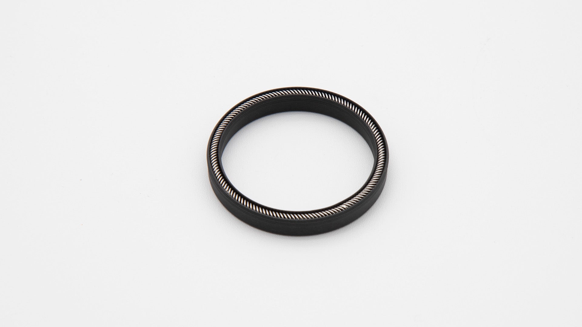 Round black object with installed spring