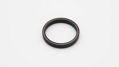 Round black object with installed spring