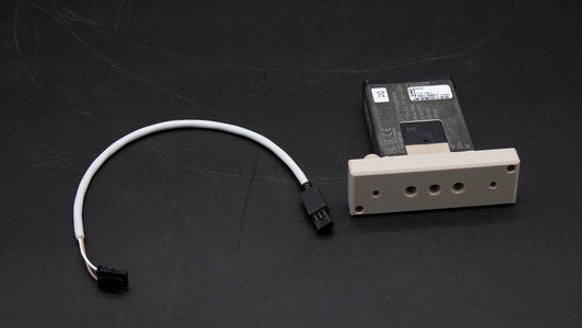 A white cable next to a rectangular object