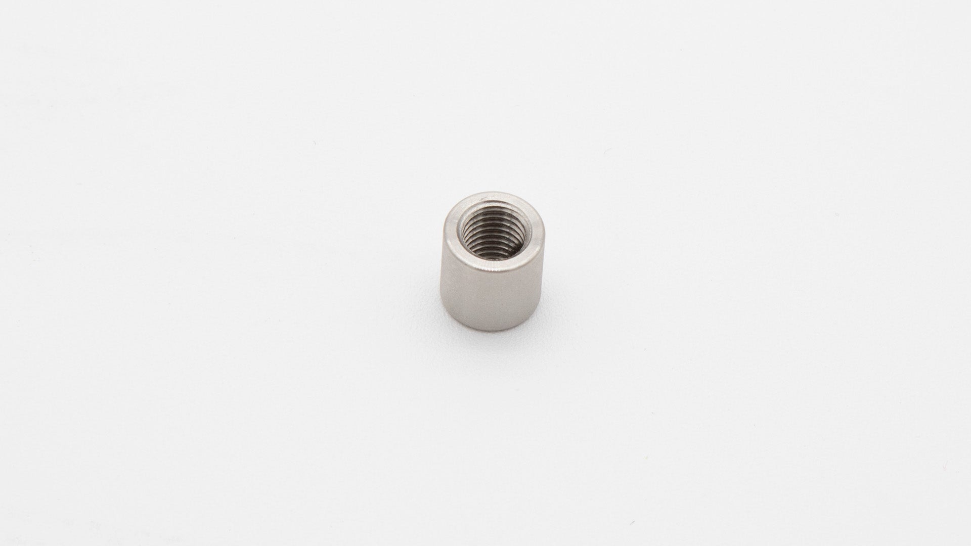 A small metal nut with a thread