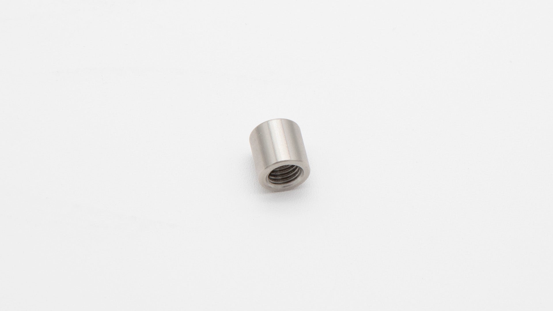 A small metal nut with a thread