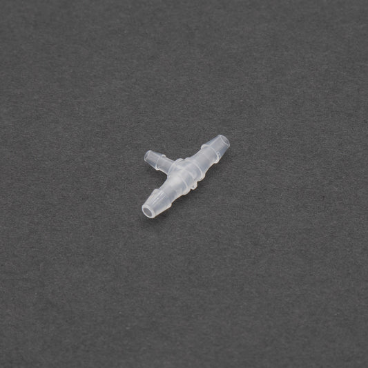 A small clear plastic piece resting on a smooth black surface, blending seamlessly with its surroundings.