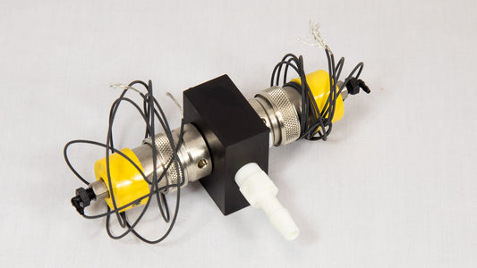 A yellow and black device featuring several attached wires, suggesting its use in a technical or electrical context.
