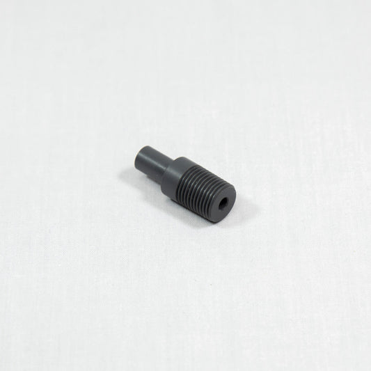 A black plastic threaded nut resting on a white surface, showcasing its circular shape and detailed threading.
