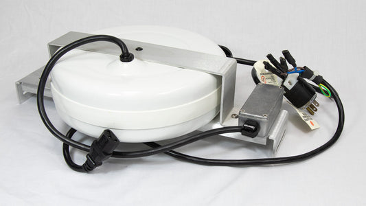 A circular white object with wires extending from it, indicating its function as an electronic component or device.