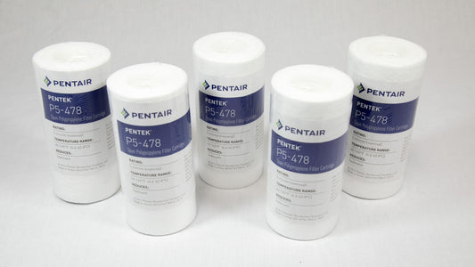 Four white filters arranged neatly on a white surface, showcasing their uniformity and design.