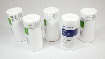 Four white filters arranged neatly on a white surface, showcasing their uniformity and design.