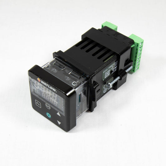 A small electronic device featuring a green and black cover, positioned on a neutral background.
