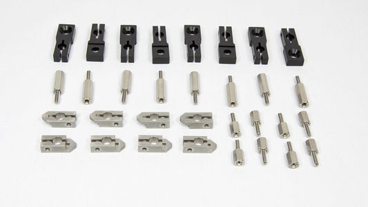An assortment of metal parts and tools intended for machine assembly, organized on a table.