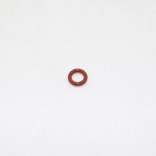 Small red rubber O-ring on a white background