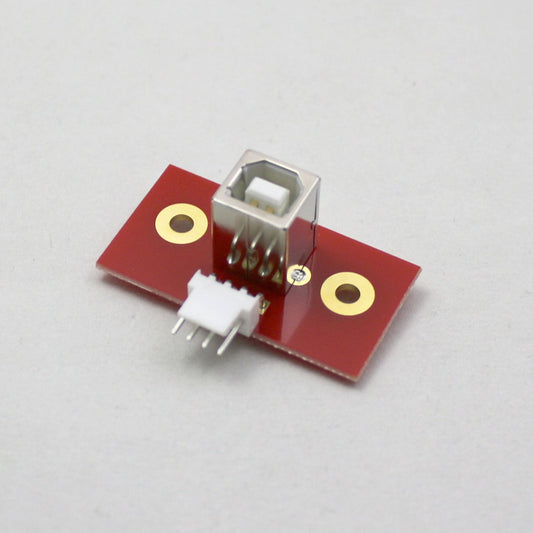 Electronic component with red board and gold contacts on a gray background