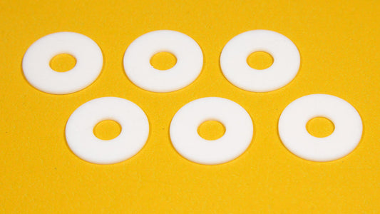 Six white round objects arranged on a bright yellow background.