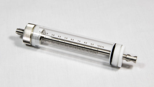 A transparent glass cylinder connected to a metal tube, representing a basic yet effective structural element.