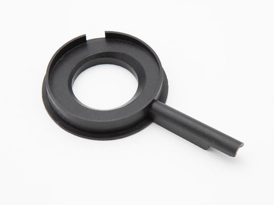 A round plastic object with handle