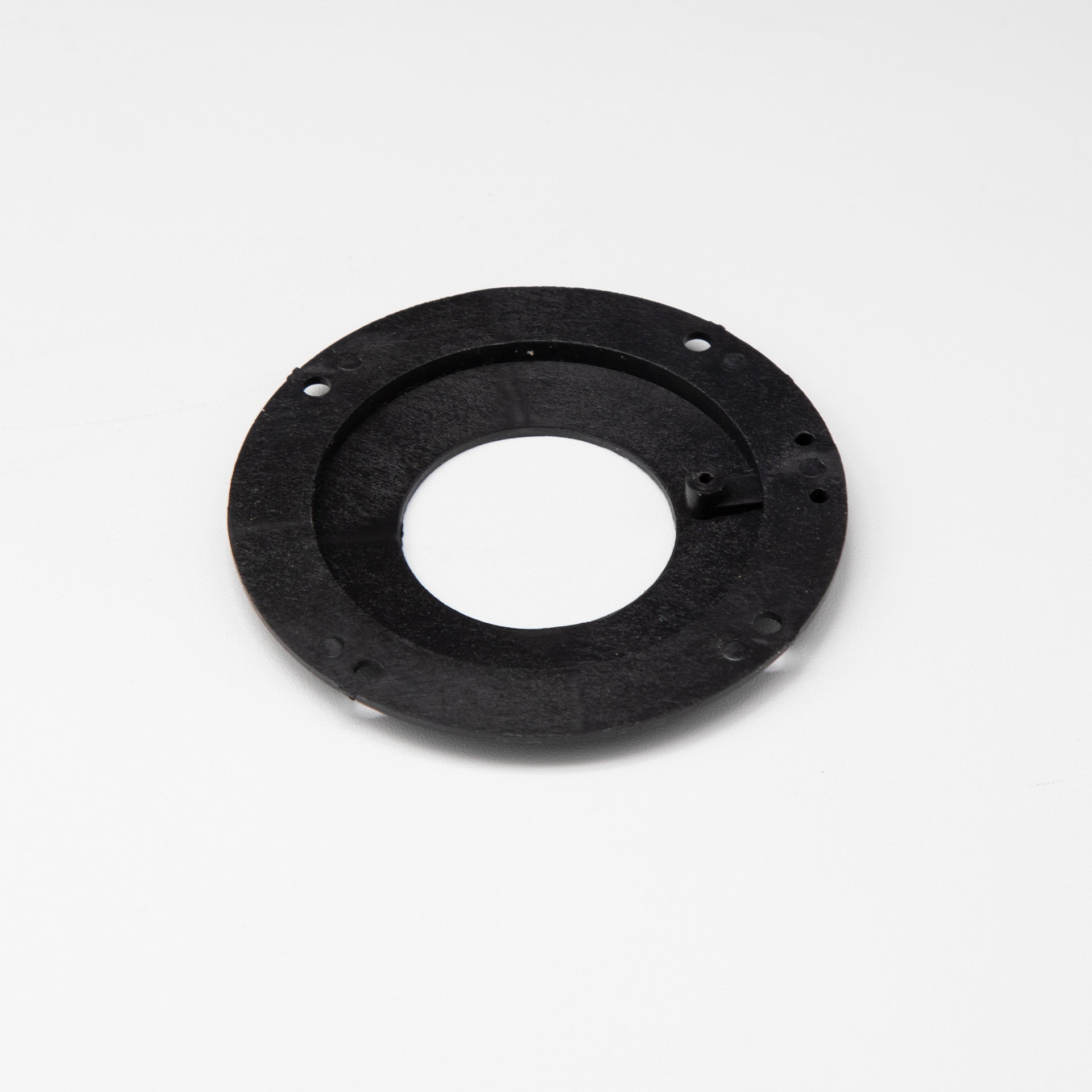 Black circular object with holes