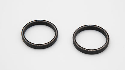 Round black objects with installed springs