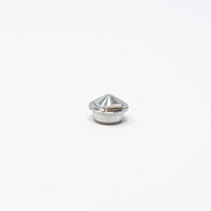A small metal nut resting on a clean white surface, showcasing its shiny texture and circular shape.