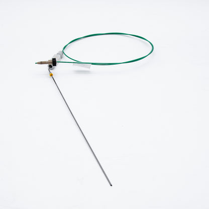 Device with green cable and needle on a white background
