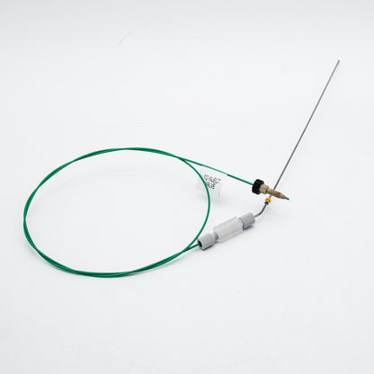 Device with green cable and needle on a white background