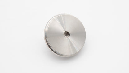 A round silver object with a nut