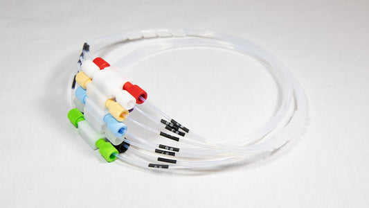 A collection of plastic tubes, each with a unique colored connector, displayed together for visual contrast.