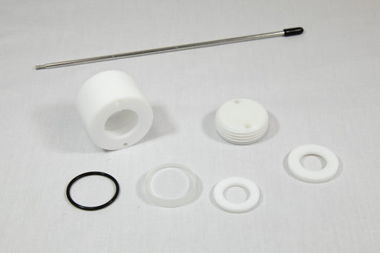 A white plastic valve, a rubber washer, and a metal rod arranged together on a neutral background.