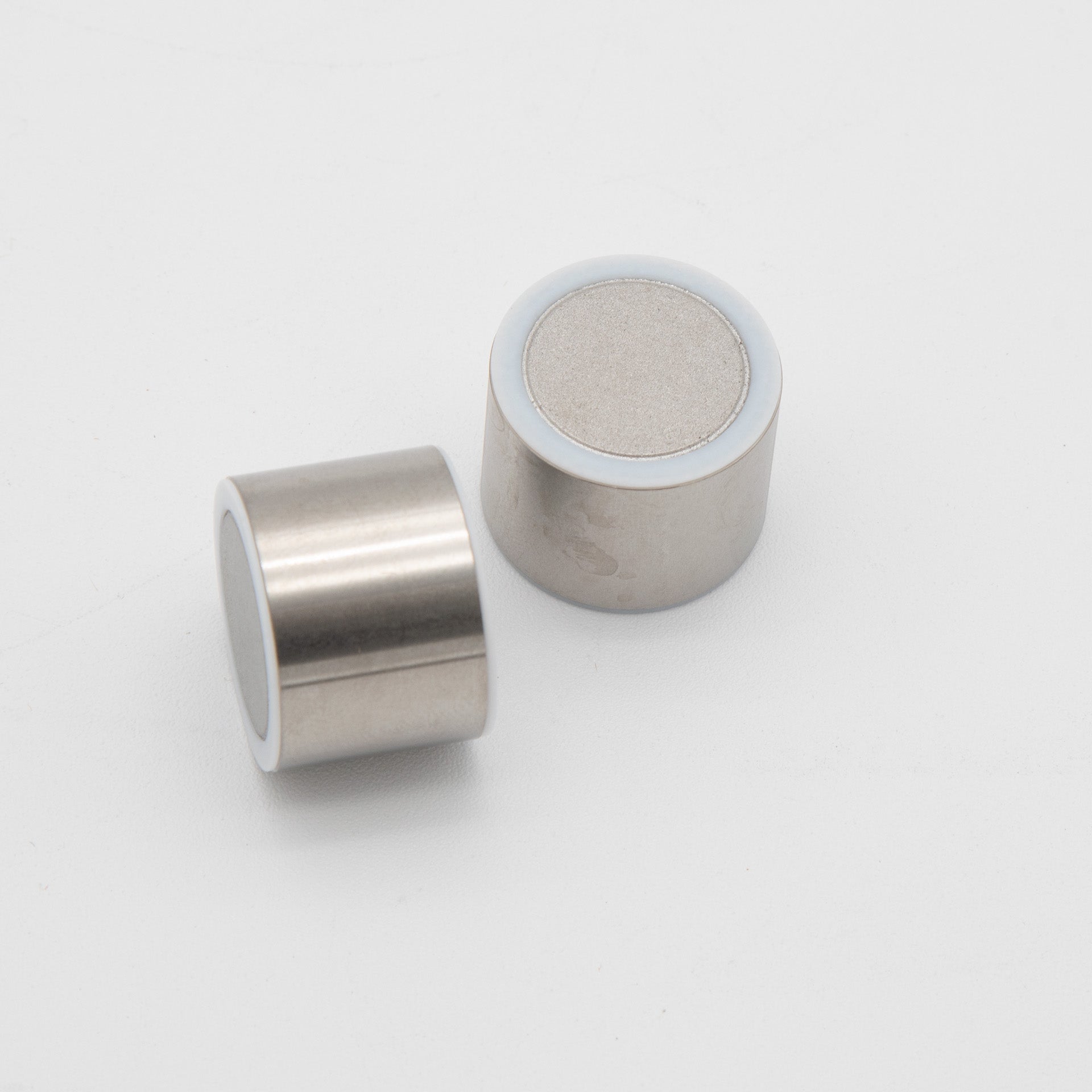 Two cylindrical silver objects