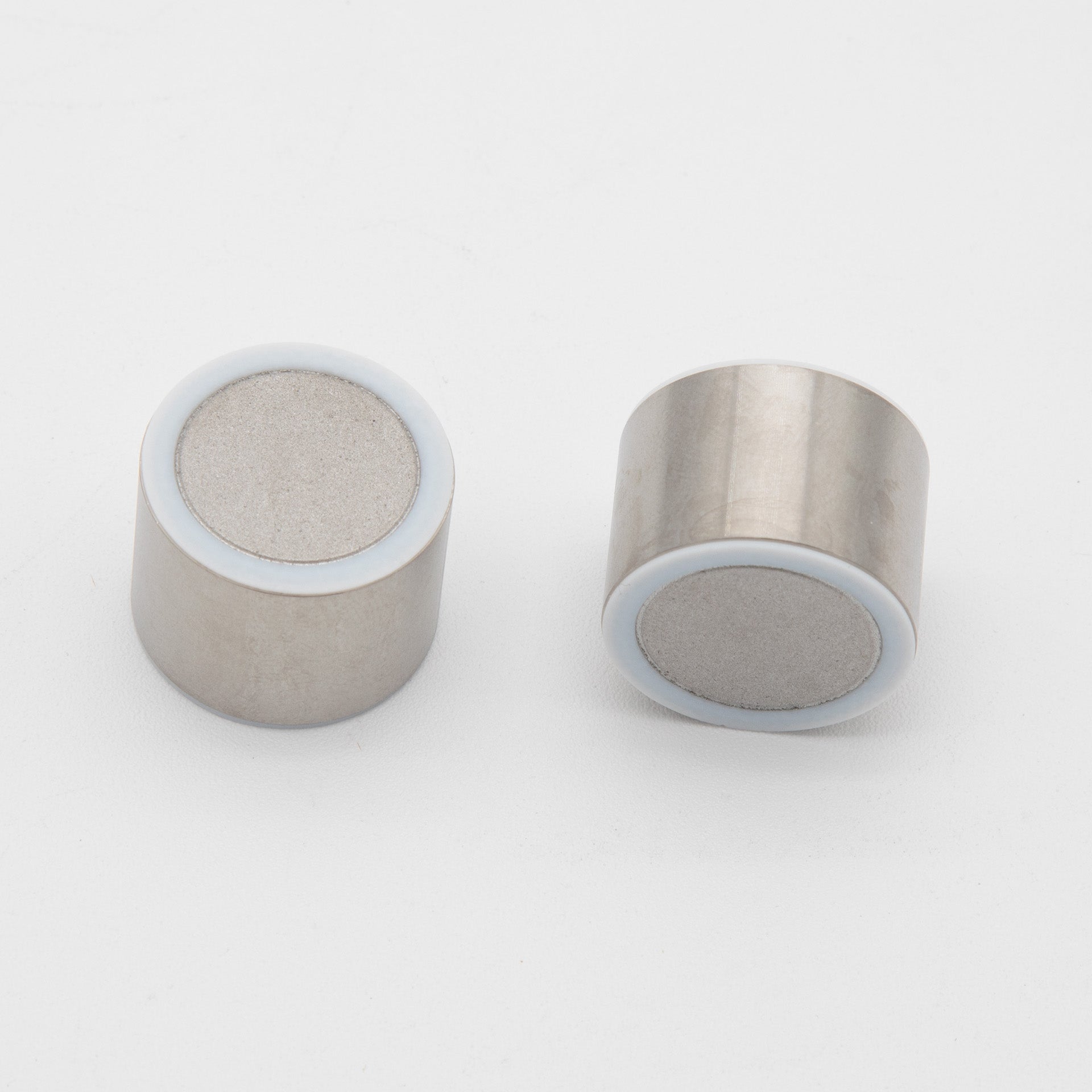 Two silver cylindrical objects