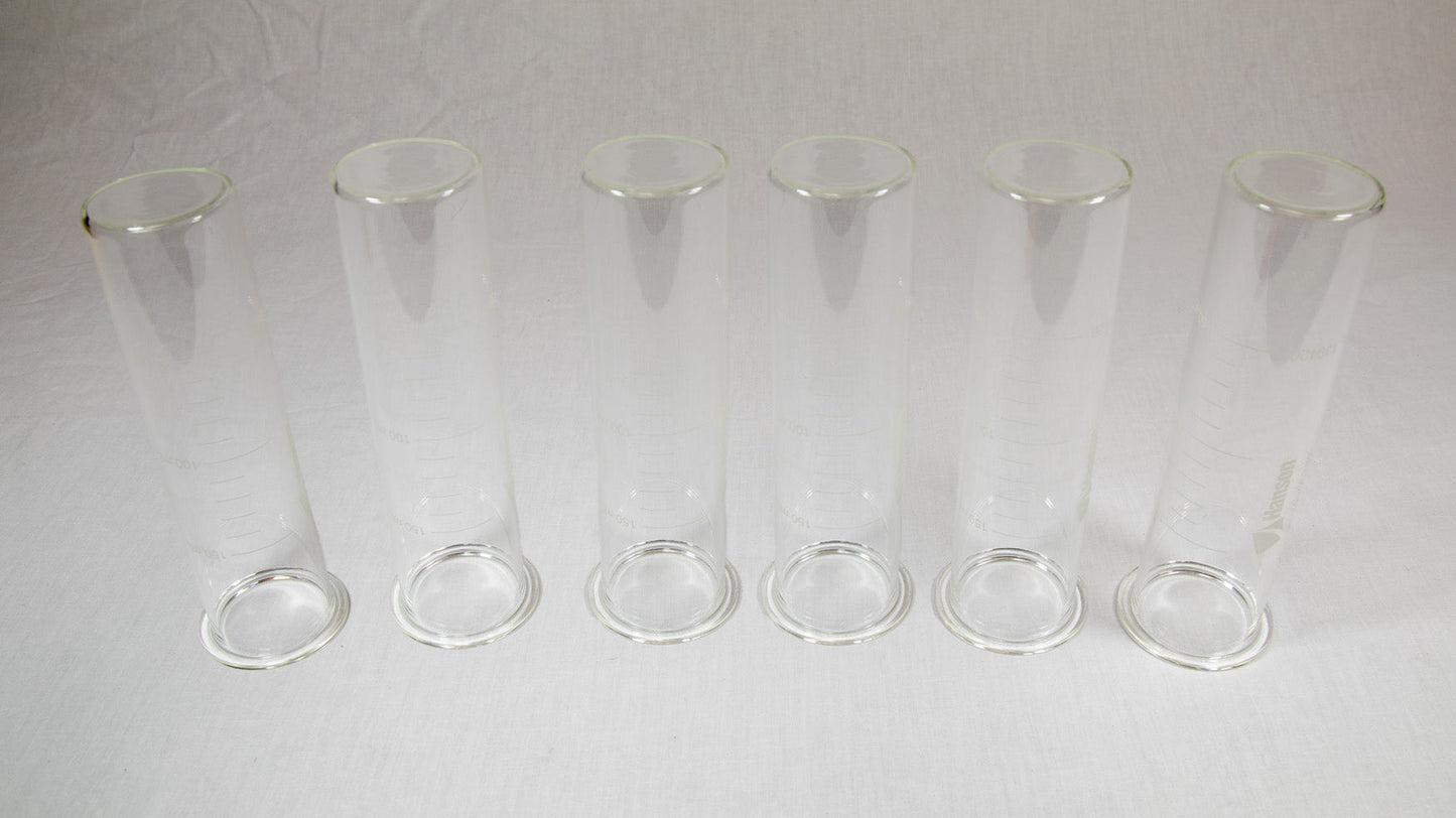 Six clear plastic containers with lids arranged neatly on a bright yellow background.