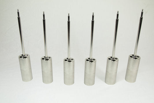 Six metal cylinders arranged together, showcasing their shapes and dimensions.
