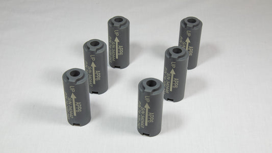 Six cylindrical black plastic objects, each with a perforation in the middle.
