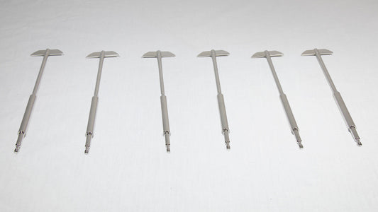 Six uniquely shaped metal rods positioned together for comparison.