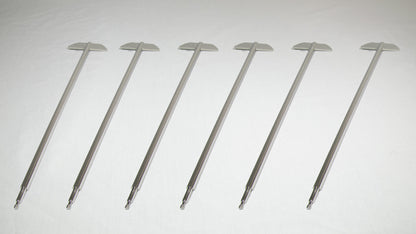 Six uniquely shaped metal rods positioned together for comparison.