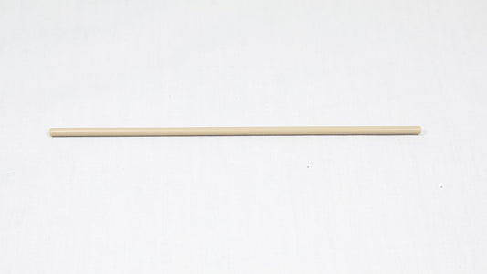 A long cylindrical shaped object pictured on a white background, creating a minimalist composition of everyday items.