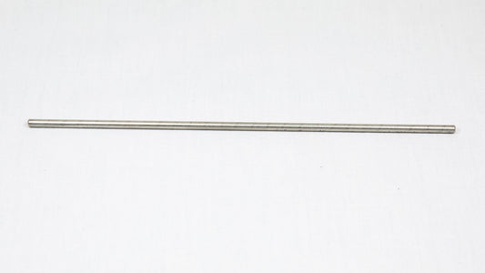 A long cylindrical shaped object pictured on a white background, creating a minimalist composition of everyday items.